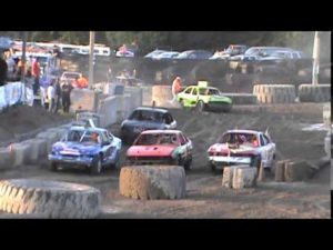 Front view of dirt cars having a race at the track
